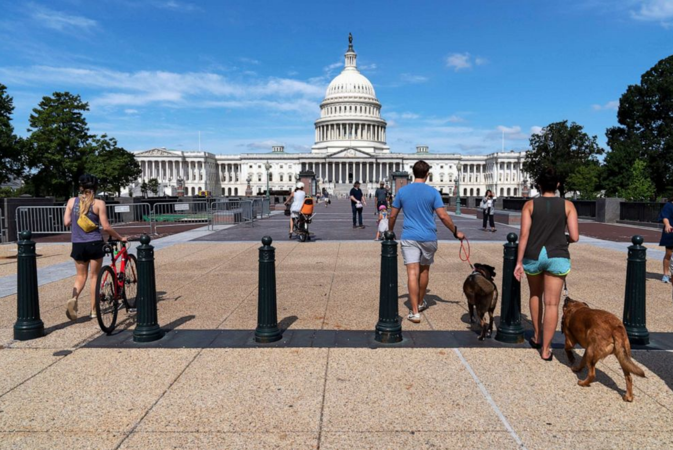 People walk to the U.S. Capitol after workers remove the fence surrounding the U.S. Capitol building, after six months of being erected following the Jan. 6 riot at the Capitol, July 10, 2021, in Washington. Jose Luis Magana/AP